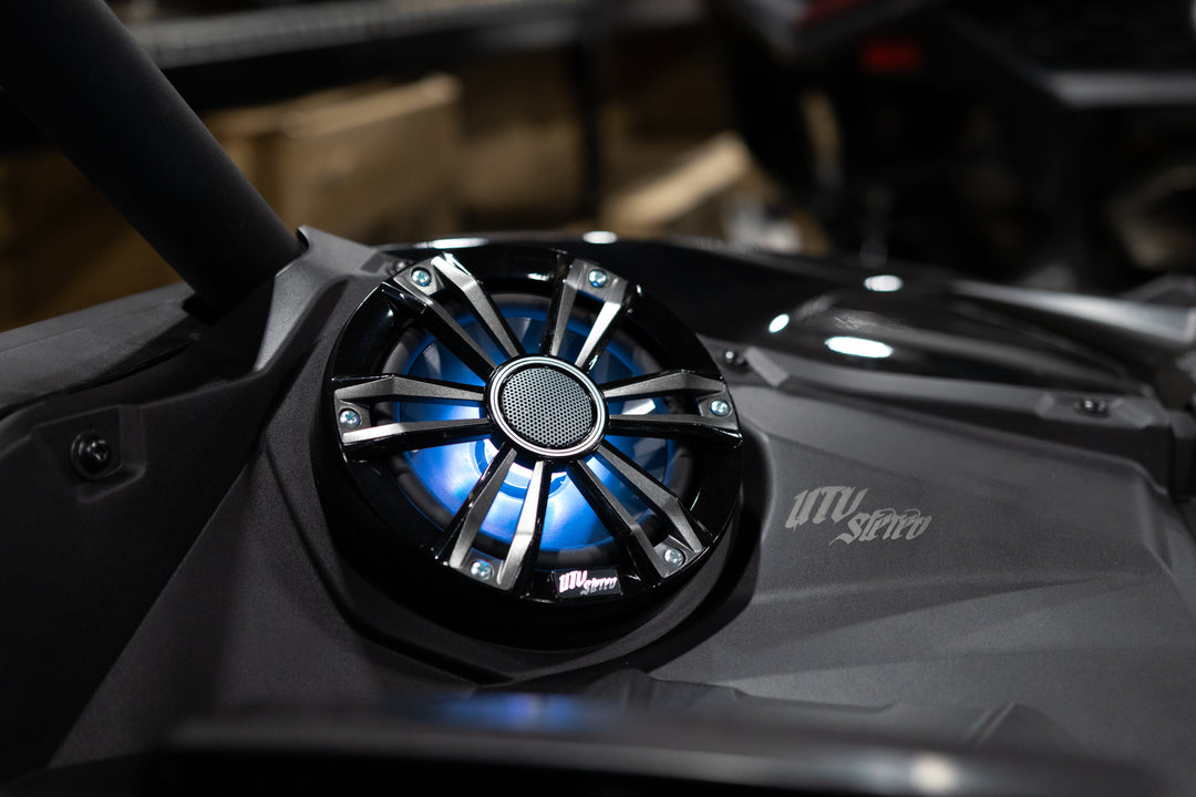 UTV Stereo speaker with blue LED lighting mounted in a black vehicle panel