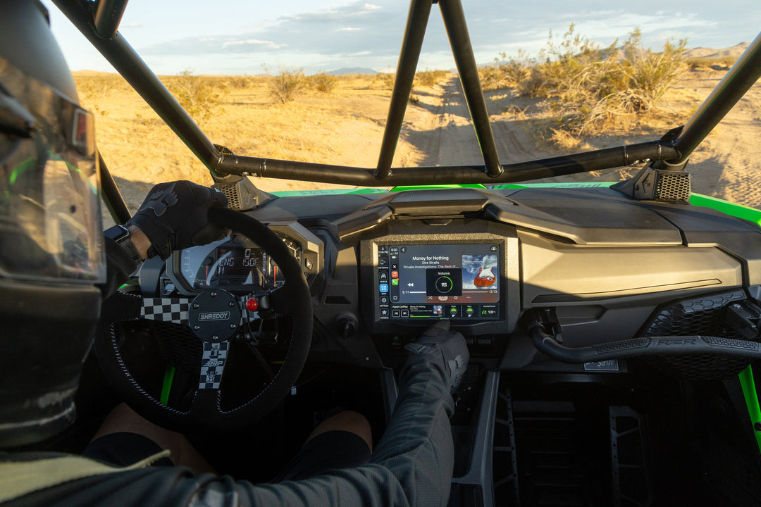 Driver operating HORIZON XTR in a UTV on a desert trail